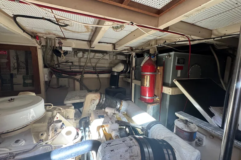 Good Enough Yacht Photos Pics Engine room of a 1990 Grand Banks 46 Classic yacht, featuring machinery and fire extinguisher.