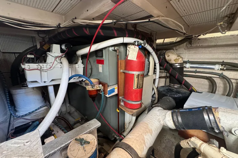 Good Enough Yacht Photos Pics Engine room of 1990 Grand Banks 46 Classic yacht, featuring fire extinguisher and mechanical components.
