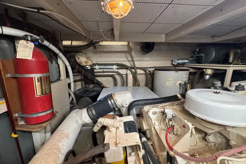 Good Enough Yacht Photos Pics Engine room of a 1990 Grand Banks 46 Classic yacht, featuring machinery and fire extinguisher.
