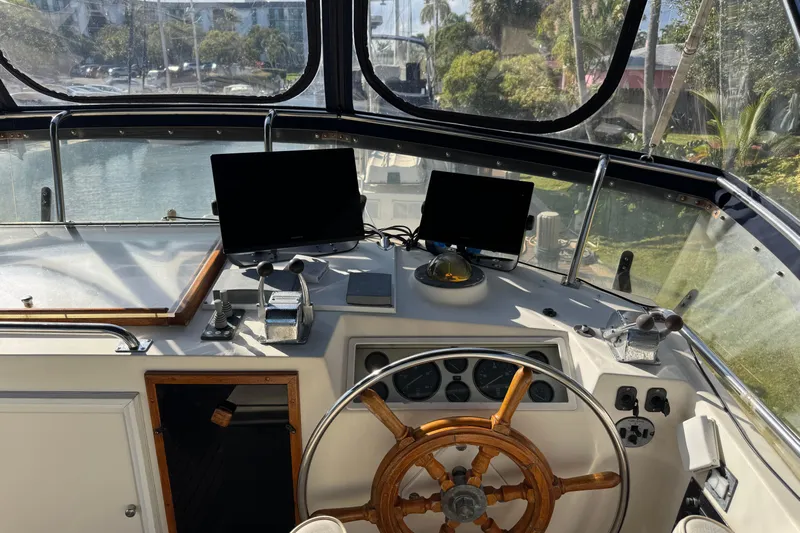 Good Enough Yacht Photos Pics Helm of 1990 Grand Banks 46 Classic yacht with wooden wheel and navigation equipment.