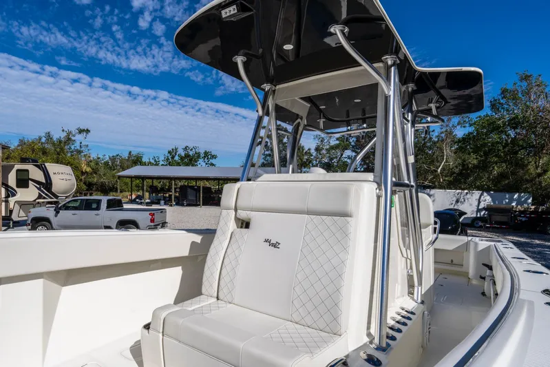 Pilar Yacht Photos Pics 2019 SeaVee 322z boat with white seating and T-top under a clear blue sky.