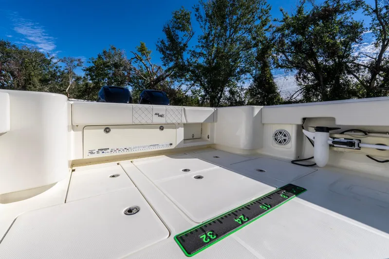 Pilar Yacht Photos Pics 2019 SeaVee 322z boat deck with storage compartments and measuring ruler.