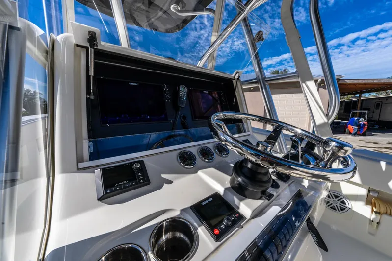 Pilar Yacht Photos Pics 2019 SeaVee 322z boat helm with modern controls and steering wheel under a clear blue sky.
