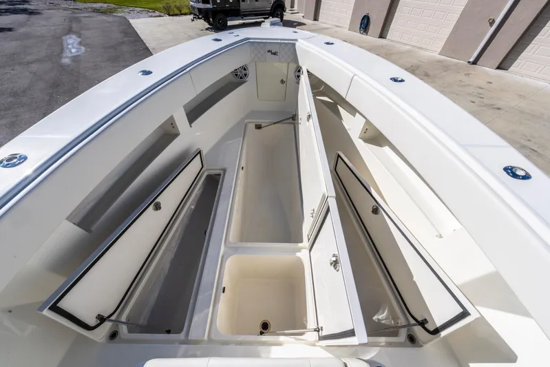 Pilar Yacht Photos Pics 2019 SeaVee 322z boat with open storage compartments, showcasing spacious deck design.