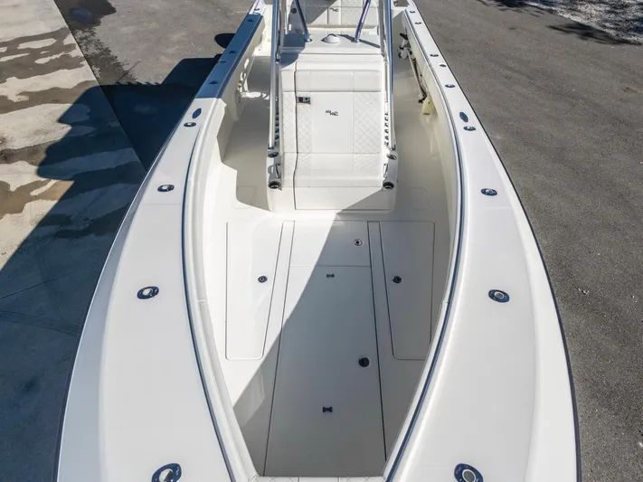 Pilar Yacht Photos Pics 2019 SeaVee 322z boat, spacious deck, white finish, docked on concrete surface.