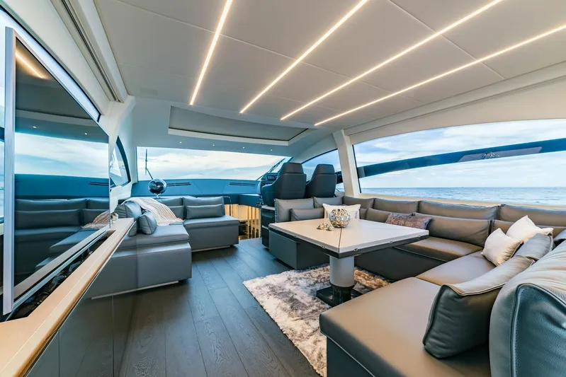 Bad Daddy Yacht Photos Pics Luxurious interior of a 2018 Pershing 70 yacht with modern seating and panoramic windows.