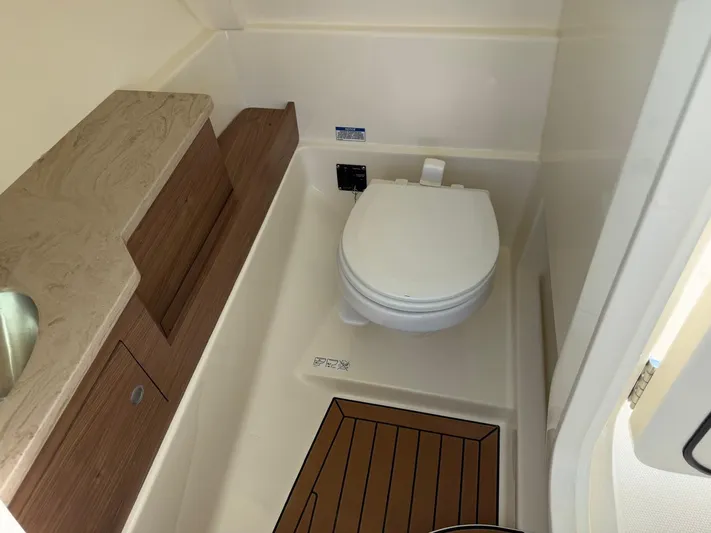  Yacht Photos Pics Interior of 2022 Boston Whaler 28 Vantage with toilet and wood paneling.