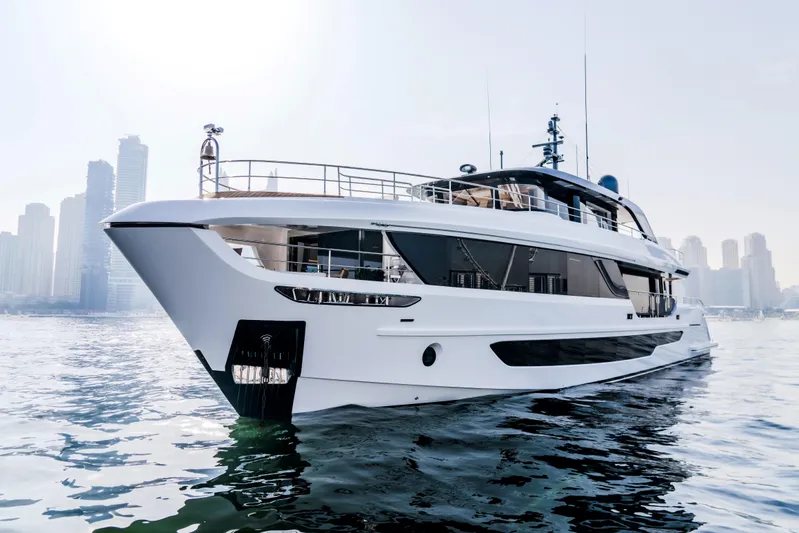  Yacht Photos Pics Luxurious 2027 Majesty 100 Terrace yacht on water with city skyline backdrop.