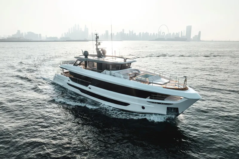  Yacht Photos Pics Luxurious 2027 Majesty 100 Terrace yacht cruising near a city skyline.