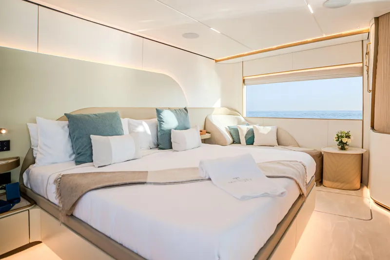  Yacht Photos Pics Luxurious bedroom on Majesty 100 Terrace yacht, 2027 model, with ocean view and elegant decor.