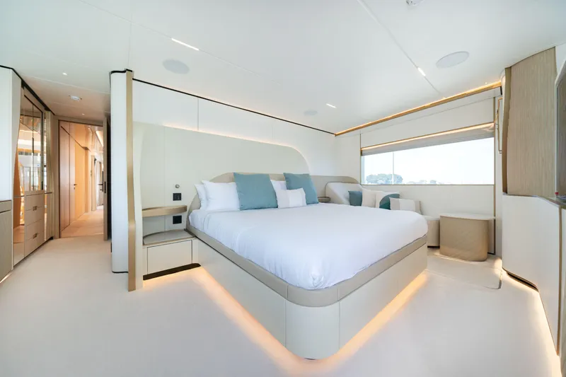  Yacht Photos Pics Luxurious bedroom interior on 2027 Majesty 100 Terrace yacht, featuring modern design and ambient lighting.