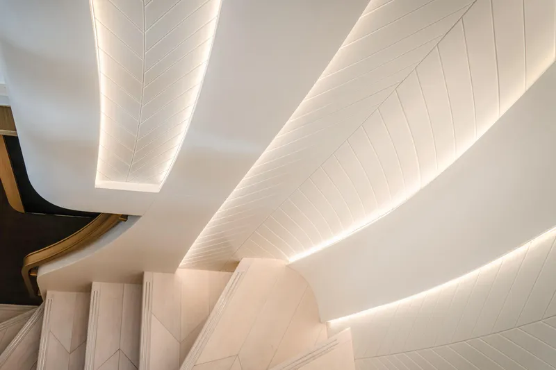  Yacht Photos Pics Luxurious interior staircase with elegant lighting in the 2027 Majesty 100 Terrace yacht.