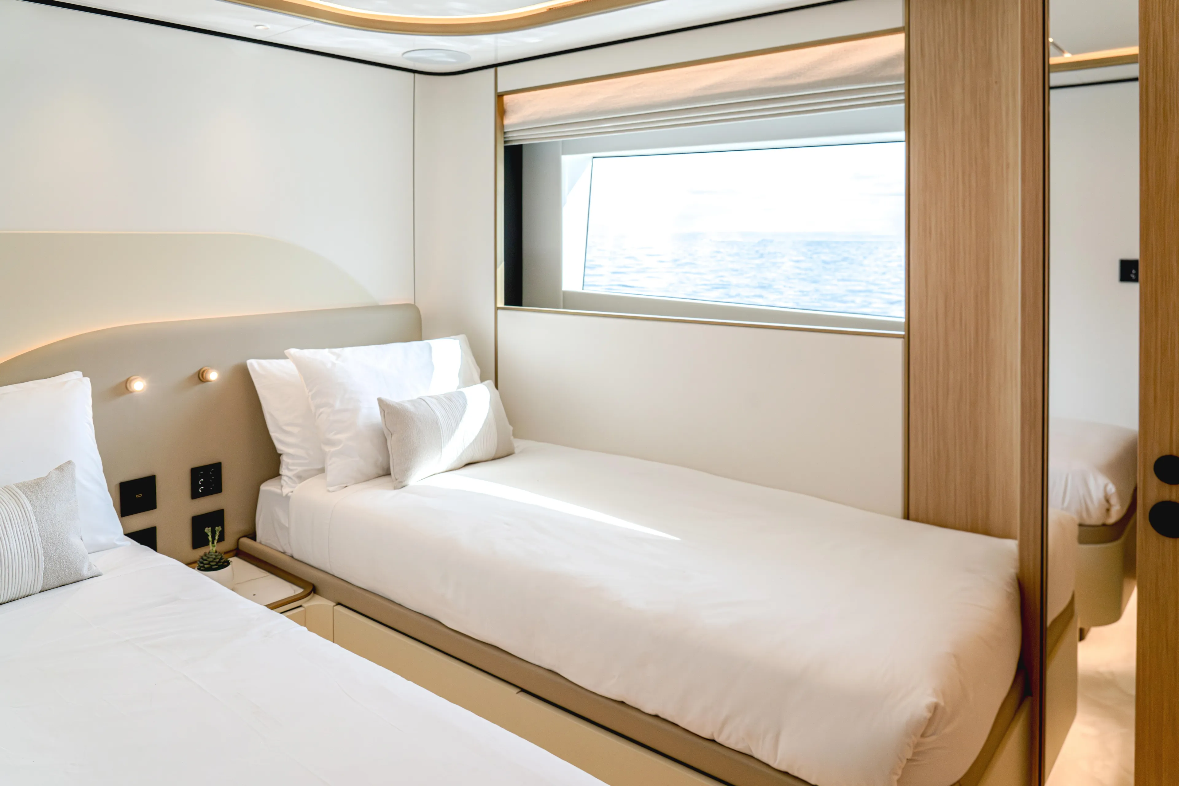  Yacht Photos Pics Luxurious bedroom in 2027 Majesty 100 Terrace yacht with ocean view window.