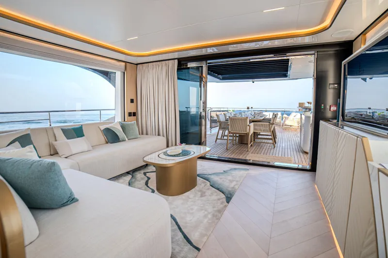  Yacht Photos Pics Luxurious interior of 2027 Majesty 100 Terrace yacht with ocean view and elegant furnishings.
