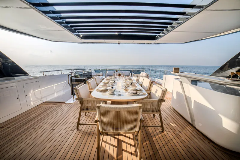  Yacht Photos Pics Luxurious dining area on 2027 Majesty 100 Terrace yacht with ocean view.