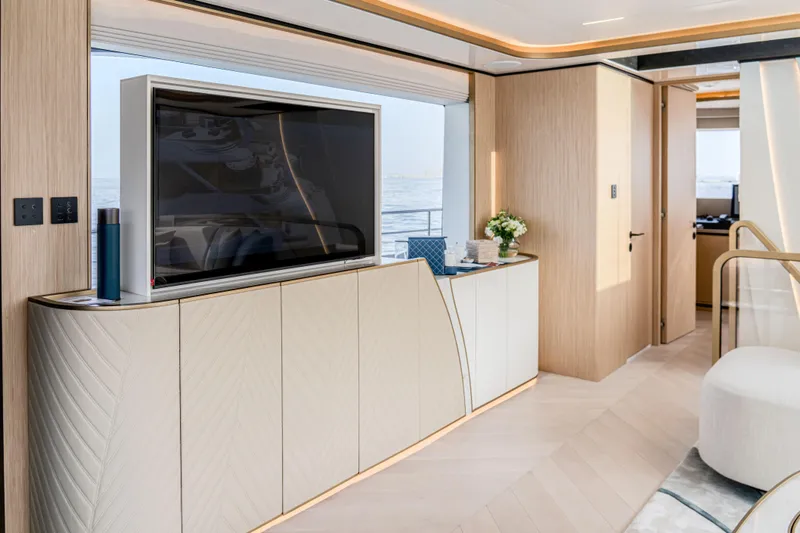  Yacht Photos Pics Luxurious interior of 2027 Majesty 100 Terrace yacht with modern TV and elegant decor.