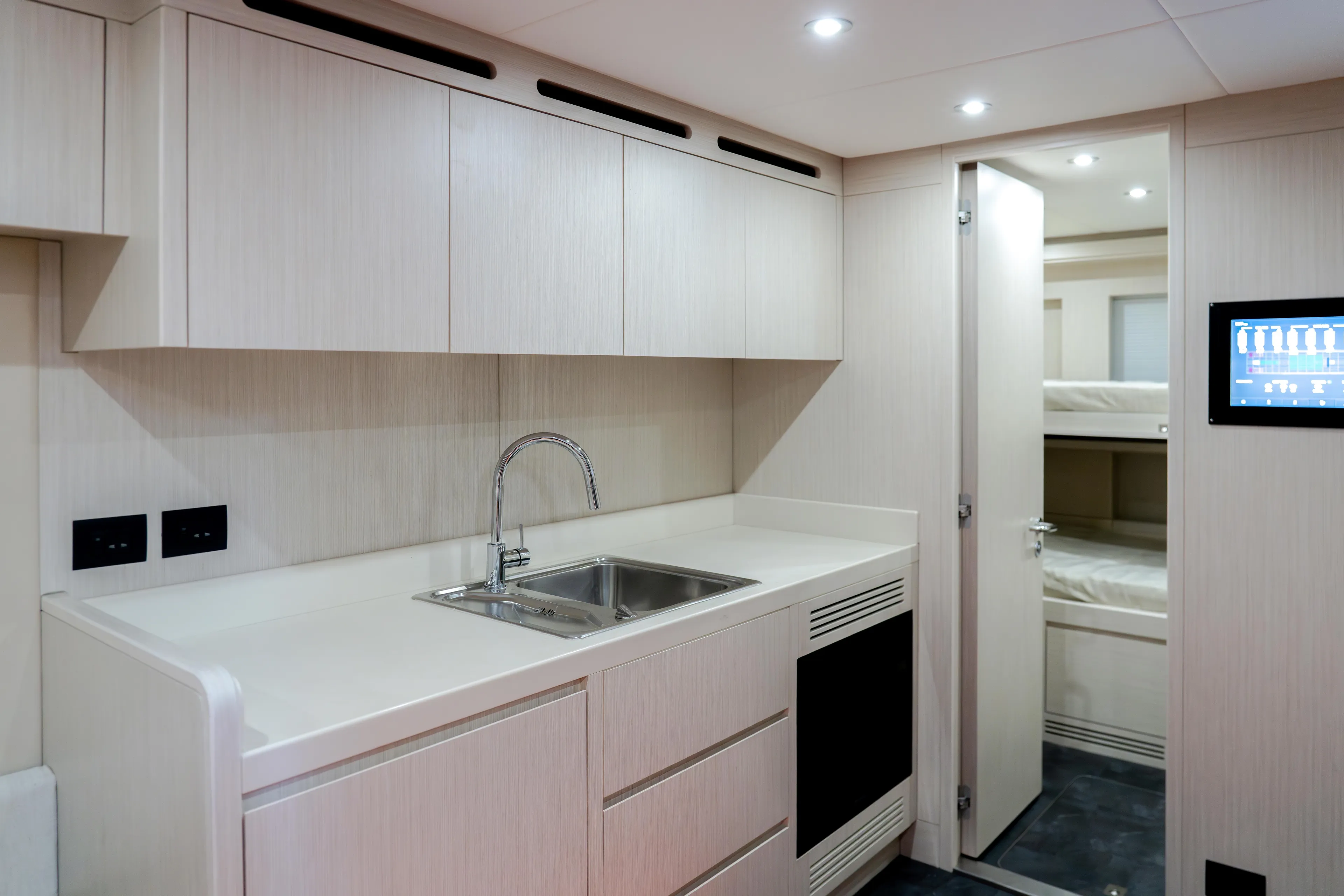  Yacht Photos Pics Modern kitchen interior on Majesty 100 Terrace yacht, 2027 model, featuring sleek cabinetry and stainless steel sink.