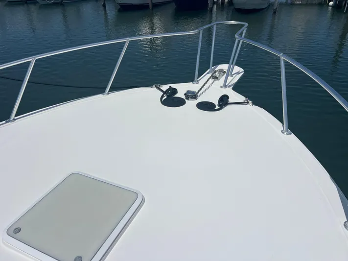  Yacht Photos Pics Bow of 2007 Topaz 32 Express boat with anchor chain, docked in marina.