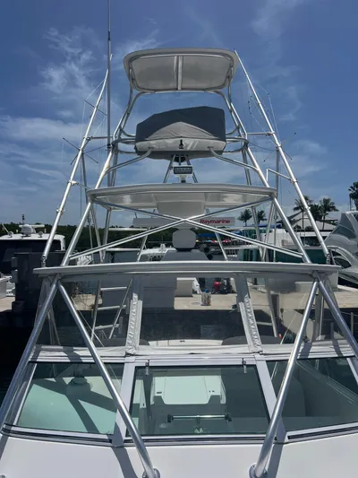  Yacht Photos Pics 2007 Topaz 32 Express boat with tower under clear blue sky.