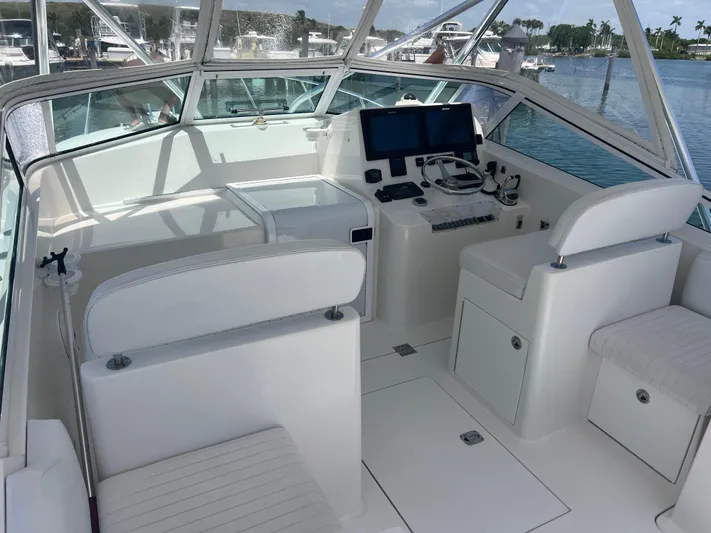  Yacht Photos Pics 2007 Topaz 32 Express boat cockpit with white seating and navigation equipment.