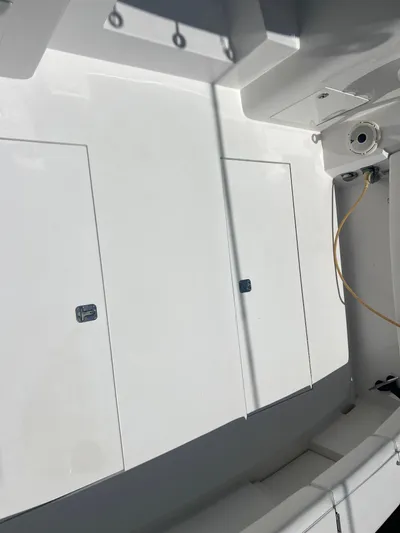  Yacht Photos Pics 2007 Topaz 32 Express boat deck with storage compartments and clean white finish.