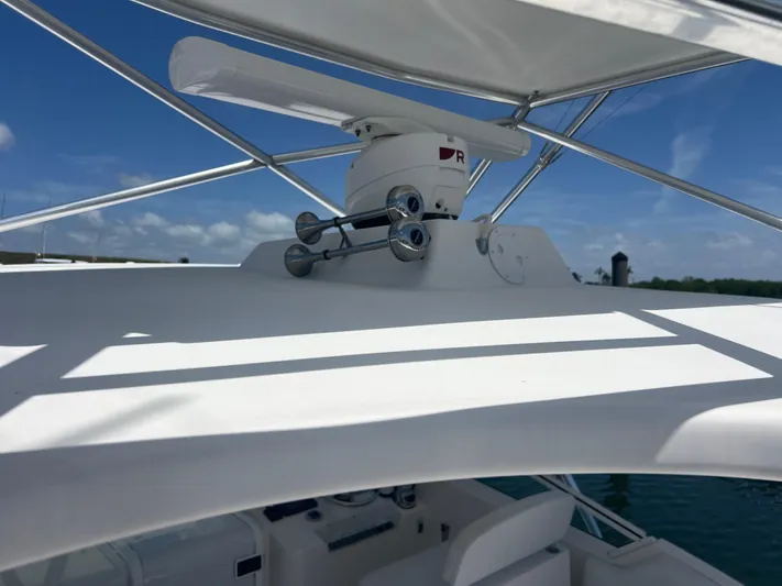  Yacht Photos Pics Radar equipment on 2007 Topaz 32 Express boat under clear blue sky.