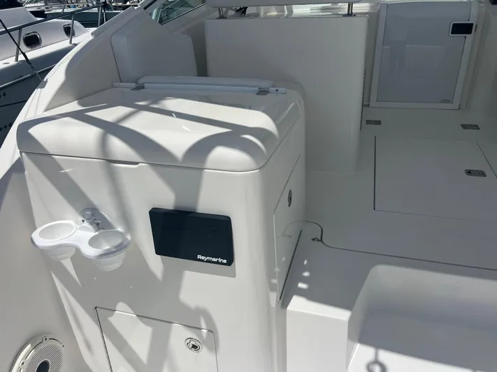  Yacht Photos Pics 2007 Topaz 32 Express boat interior with Raymarine equipment and cup holders.