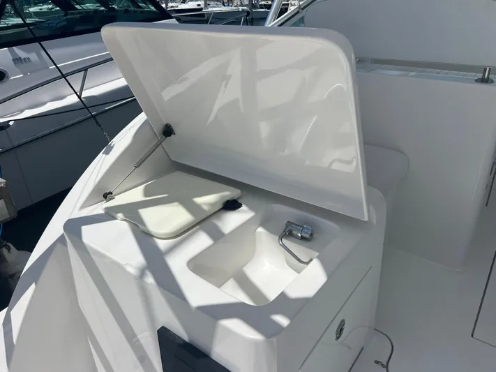  Yacht Photos Pics 2007 Topaz 32 Express boat sink and storage area with open lid.