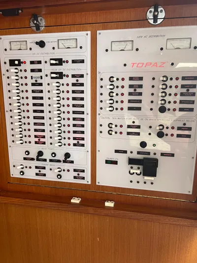  Yacht Photos Pics Electrical control panel on a 2007 Topaz 32 Express boat, featuring various switches and gauges.