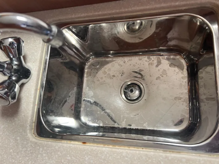  Yacht Photos Pics Stainless steel sink with faucet in 2007 Topaz 32 Express boat kitchen.