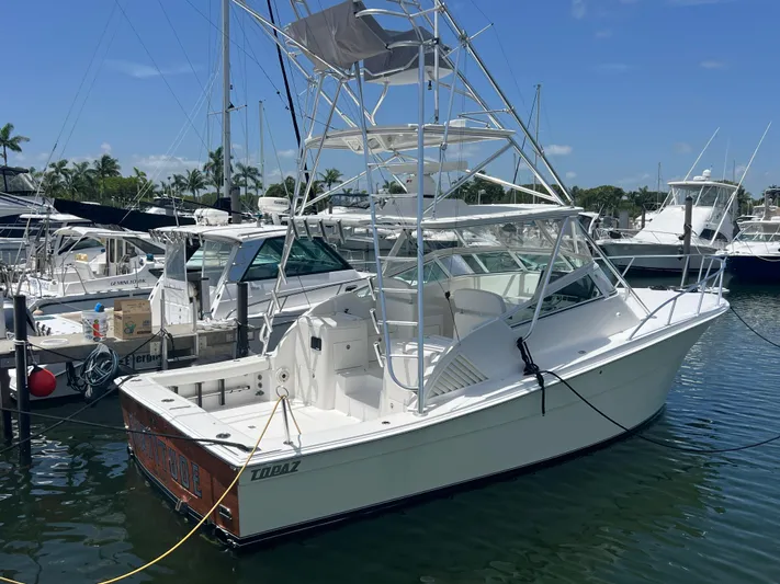  Yacht Photos Pics 2007 Topaz 32 Express boat docked in marina, clear sky, calm water.