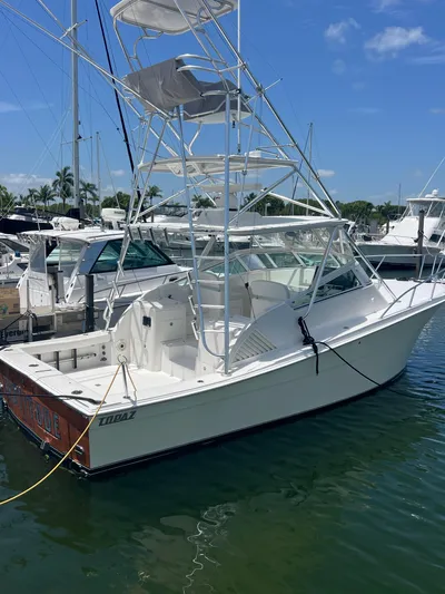  Yacht Photos Pics 2007 Topaz 32 Express boat docked in marina under clear blue sky.