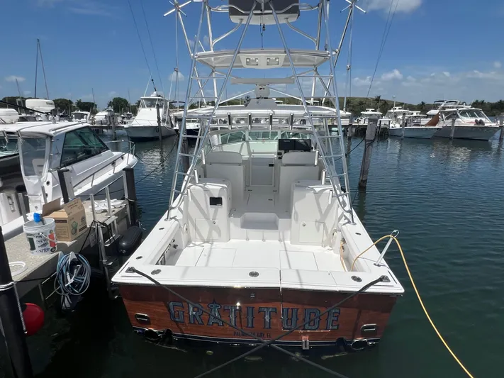  Yacht Photos Pics 2007 Topaz 32 Express boat docked in marina, clear sky, calm water.