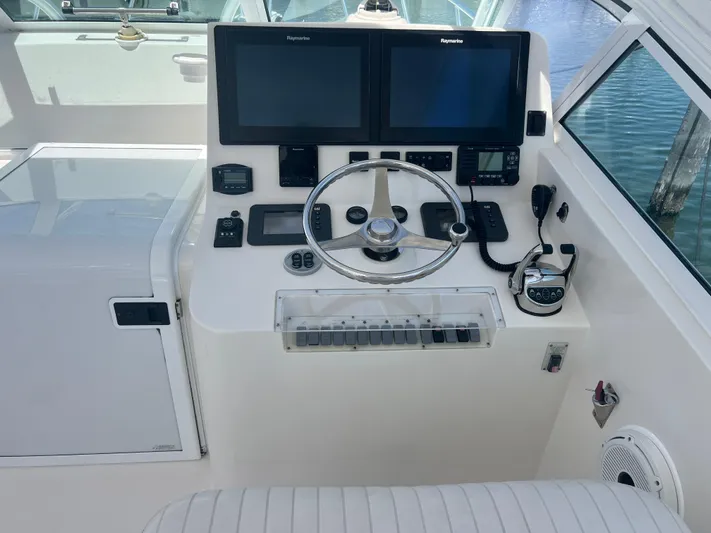  Yacht Photos Pics 2007 Topaz 32 Express helm with dual Raymarine displays and modern controls.