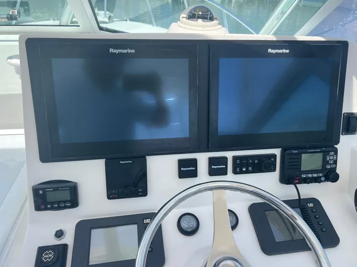  Yacht Photos Pics Control panel of 2007 Topaz 32 Express boat with Raymarine displays and navigation equipment.