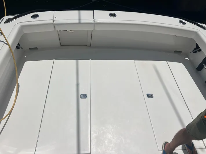  Yacht Photos Pics 2007 Topaz 32 Express boat deck with storage compartments and seating.