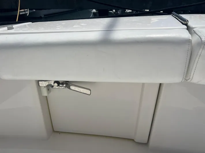  Yacht Photos Pics White cushioned seat with a metal latch on a 2007 Topaz 32 Express boat.