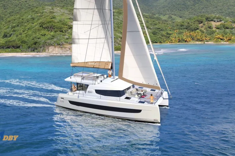 Ellidy Yacht Photos Pics 2025 Bali 4.4 catamaran sailing near tropical island with lush greenery and clear blue waters.