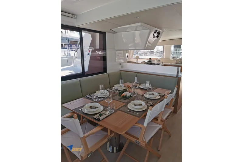 Ellidy Yacht Photos Pics Elegant dining area on 2025 Bali 4.4 yacht, set for a meal with stylish tableware.