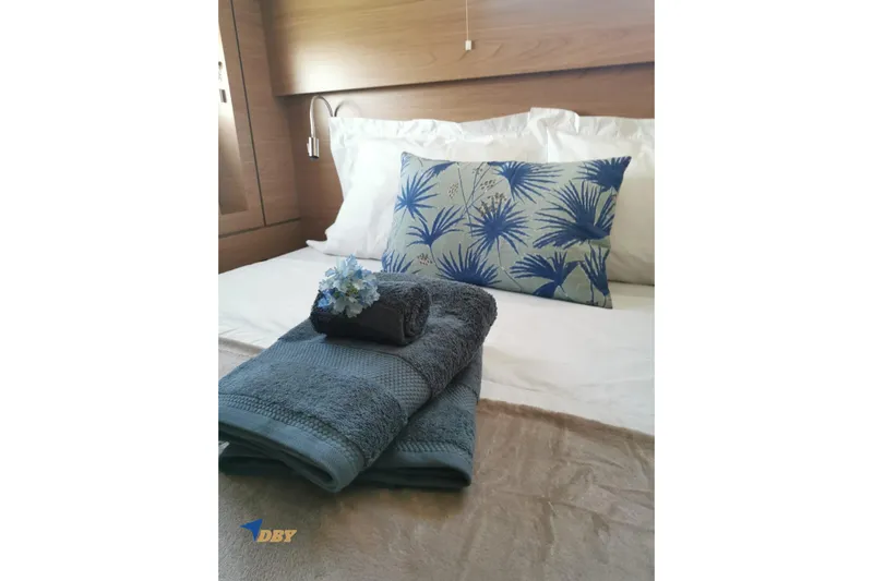 Ellidy Yacht Photos Pics Luxurious Bali 4.4 yacht bedroom with elegant bedding and decorative pillows, 2025 model.