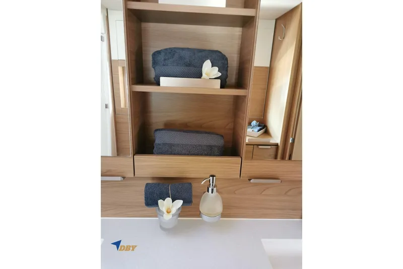 Ellidy Yacht Photos Pics Modern bathroom with wooden shelves, towels, and a flower, in a 2025 Bali 4.4 model.