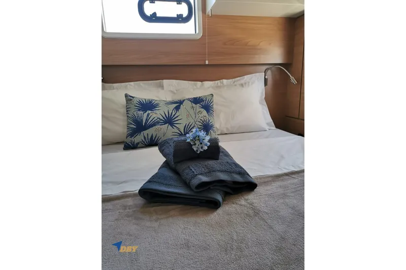 Ellidy Yacht Photos Pics Cozy bedroom in 2025 Bali 4.4 yacht with elegant bedding and decorative pillows.