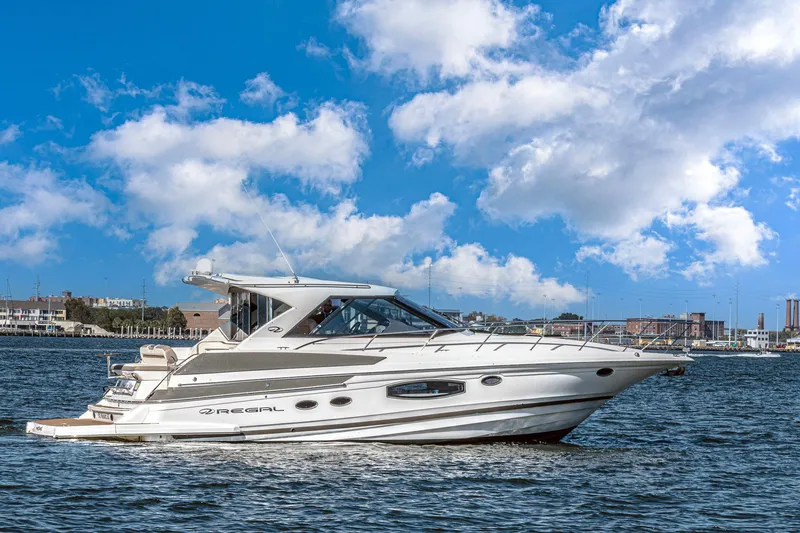  Yacht Photos Pics 2016 Regal 46 Sport Coupe yacht cruising on a sunny day with blue skies.