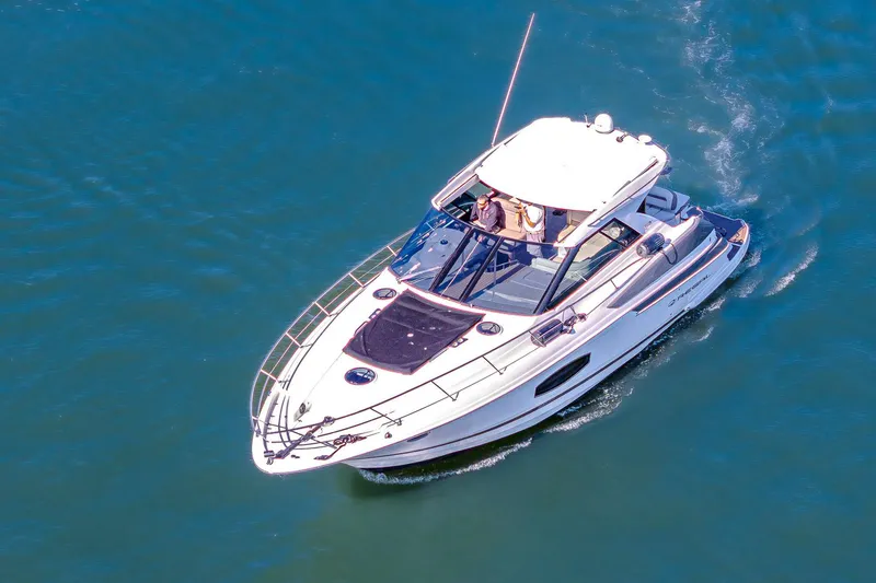  Yacht Photos Pics 2016 Regal 46 Sport Coupe cruising on open water, aerial view.