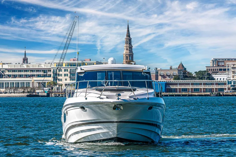  Yacht Photos Pics 2016 Regal 46 Sport Coupe yacht cruising near urban waterfront skyline.