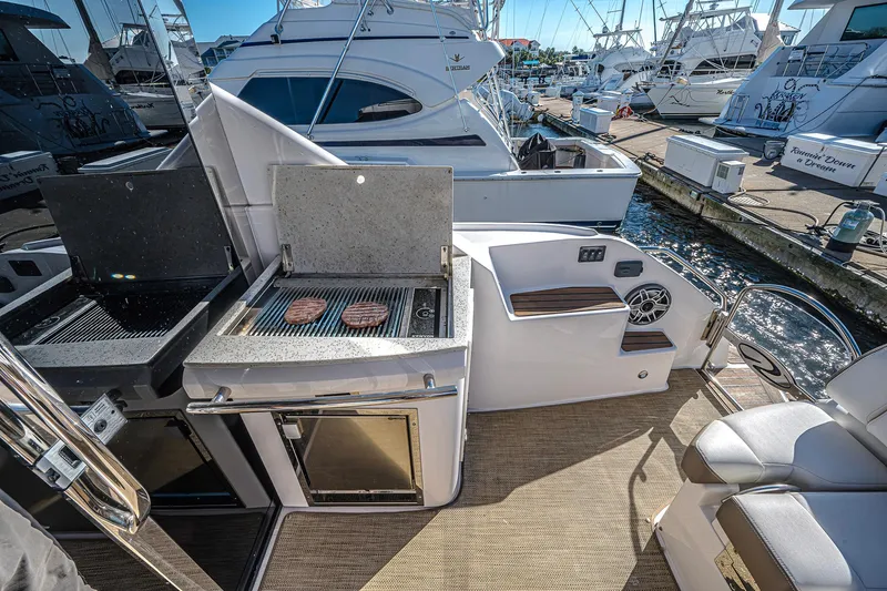  Yacht Photos Pics Outdoor grill on 2016 Regal 46 Sport Coupe yacht, docked at marina.