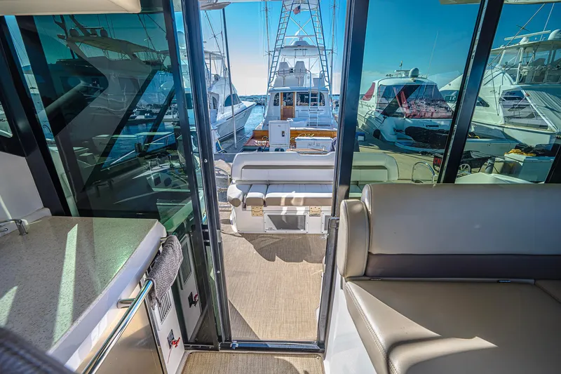  Yacht Photos Pics Interior view of 2016 Regal 46 Sport Coupe yacht with marina backdrop.