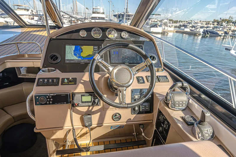  Yacht Photos Pics Helm of 2016 Regal 46 Sport Coupe with navigation screens and controls, docked at marina.