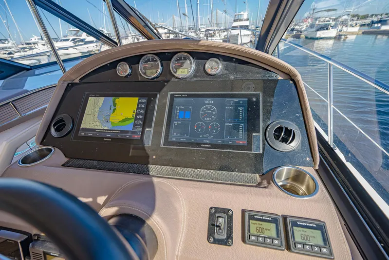  Yacht Photos Pics Dashboard of a 2016 Regal 46 Sport Coupe yacht with navigation screens and gauges.