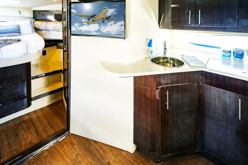  Yacht Photos Pics Interior of 2016 Regal 46 Sport Coupe with kitchenette and cozy sleeping area.